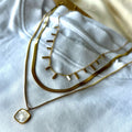 Gold necklaces on a white fabric background